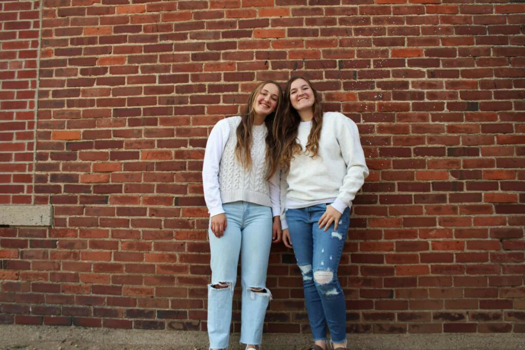 Standing with a brick wall background